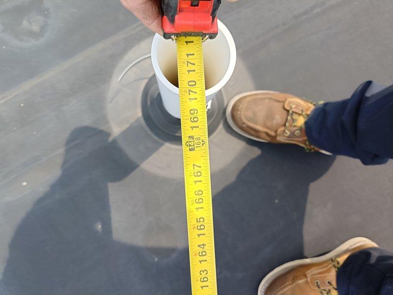 Conducted site visit to document existing air conditioning system for replacement estimate. Measured and photographed rooftop HVAC components, including PVC vent pipe depth measurements to assess current installation specifications. Documentation completed for preparation of equipment replacement proposal.