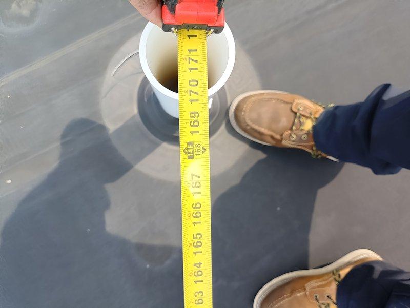 Conducted site visit to document existing air conditioning system for replacement estimate. Measured and photographed rooftop HVAC components, including PVC vent pipe depth measurements to assess current installation specifications. Documentation completed for preparation of equipment replacement proposal.