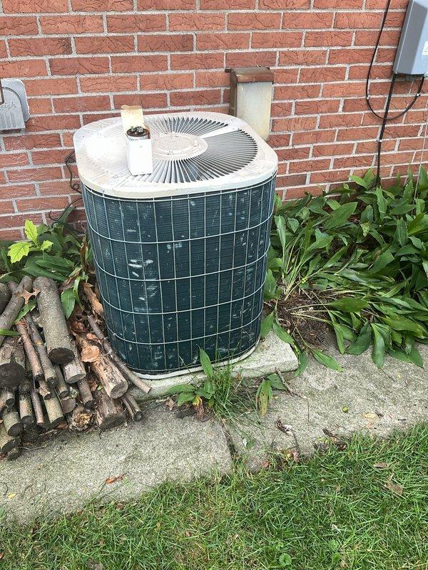 Responded to no-cooling call on residential air conditioning system. Upon arrival, found outdoor condenser unit inoperative with fan motor attempting to start but failing to run. Diagnosed failed capacitor as root cause of fan motor failure. Removed old TITAN HD capacitor (model PRCFD355A) and installed new replacement capacitor. Tested system operation and confirmed condenser fan motor running properly and unit cooling normally. System restored to full operation.