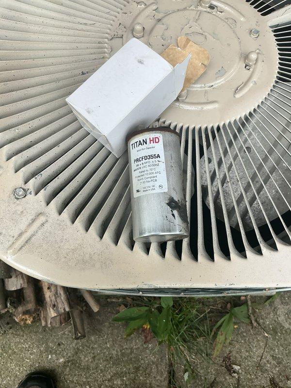 Responded to no-cooling call on residential air conditioning system. Upon arrival, found outdoor condenser unit inoperative with fan motor attempting to start but failing to run. Diagnosed failed capacitor as root cause of fan motor failure. Removed old TITAN HD capacitor (model PRCFD355A) and installed new replacement capacitor. Tested system operation and confirmed condenser fan motor running properly and unit cooling normally. System restored to full operation.