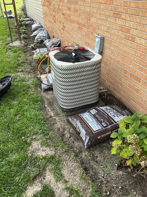 Responded to no cooling call on 19-year-old residential air conditioning system. Customer reported unit stopped cooling the previous night and was unfamiliar with equipment details after recently moving into the property. Accessed outdoor condensing unit located against exterior brick wall and furnace in garage via customer-provided entry.

Upon arrival, performed visual inspection of outdoor unit revealing aged cylindrical condenser with significant wear on concrete pad and surrounding area. Connected manifold gauges using service ports with refrigerant lines to assess system pressures and diagnose cooling failure. Evaluated electrical disconnect, condensing unit components, and refrigerant circuit for potential failures common in systems approaching two decades of service life.

Given the advanced age of the equipment at 19 years—well beyond typical 10-15 year expected lifespan—discussed findings with customer regarding system condition and repair versus replacement considerations. D