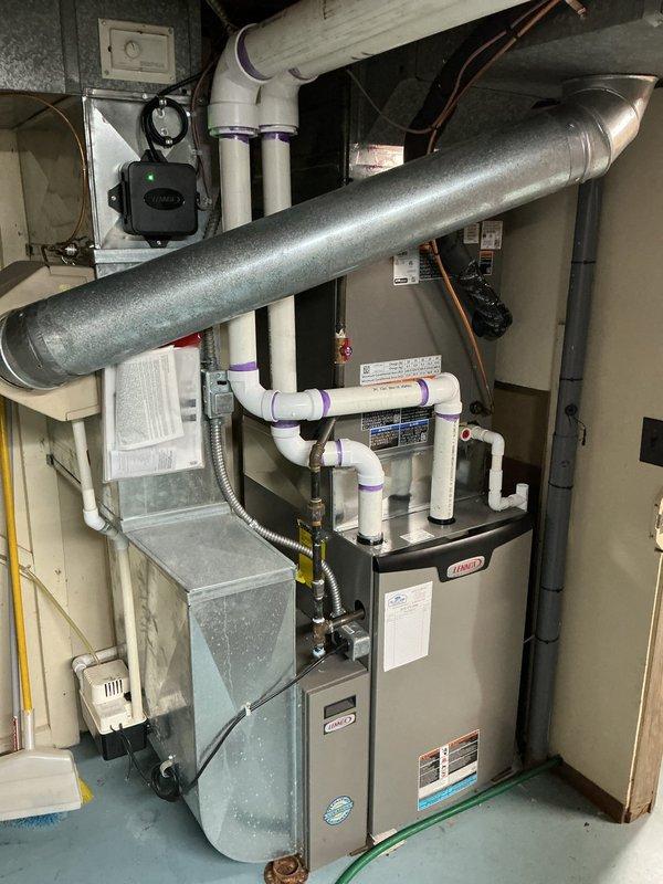 Completed installation of a new 3-ton air conditioning system with matching evaporator coil in residential utility space. Installed Size C evaporator coil measuring 21" width x 24.5" height x 21.25" depth, connected with refrigerant line set under 30 feet to new outdoor condensing unit positioned on concrete pad against brick exterior wall. Recovered and reused existing dual capacitor from previous system, integrated all electrical connections including disconnect box, and verified proper refrigerant charge and system operation upon startup.