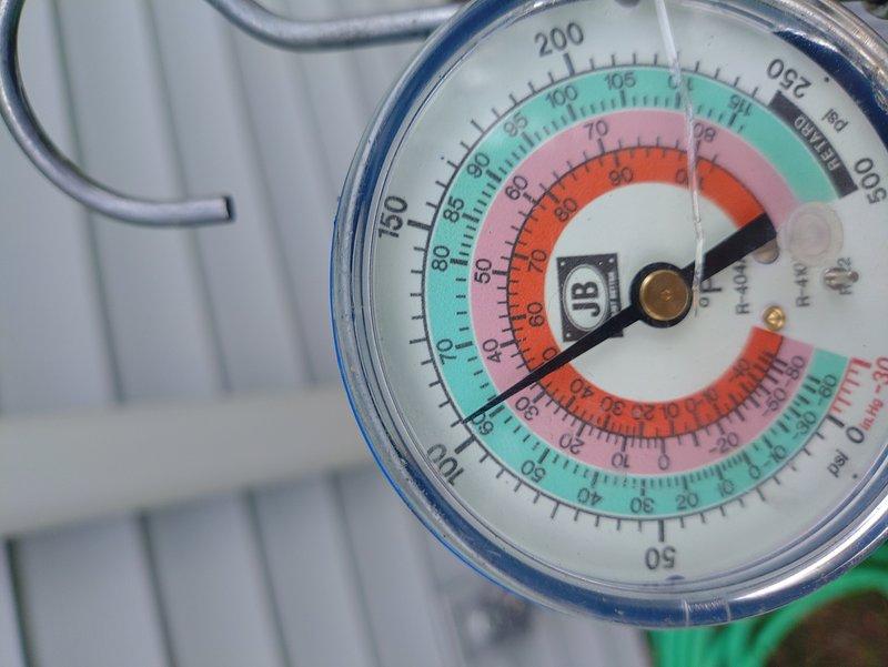 Performed annual maintenance on 1-year-old air conditioning system at vacant unit. Measured refrigerant pressures using manifold gauges, which showed readings within normal operating range. Inspected condenser unit exterior and internal components including coils and heat exchanger, noting accumulated debris and dust on surfaces that will require cleaning during future service visits.