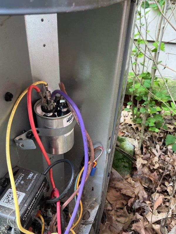 Responded to no cooling complaint on 9-year-old air conditioning system with indoor temperature at 80 degrees. Customer reported hearing blower operation but no airflow from registers. Upon inspection, accessed outdoor condensing unit and found failed dual run capacitor preventing compressor from starting. Replaced defective capacitor with proper OEM replacement, verified correct microfarad ratings for both compressor and condenser fan motor. Tested system operation, confirmed compressor startup, proper refrigerant pressures, and adequate airflow at supply registers. System restored to normal cooling operation.