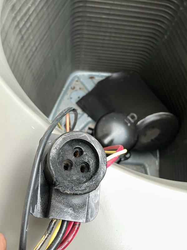 Returned to site to perform leak search on HVAC system. Inspected compressor unit and refrigerant lines, documenting condition of copper tubing and electrical connections with photos. System shows signs of operational wear with visible dust accumulation on components. Leak search in progress; awaiting confirmation on warranty status before ordering replacement parts if needed.
