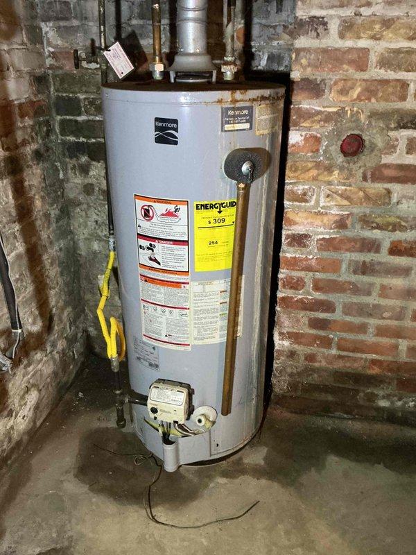 Completed scheduled maintenance on a 5-year-old gas-powered Kenmore water heater. Performed visual inspection of unit, verified proper operation of all controls and safety devices, and checked pipe connections and venting system for integrity. All components found to be functioning within normal parameters, with minor age-appropriate wear noted on copper piping and unit exterior.