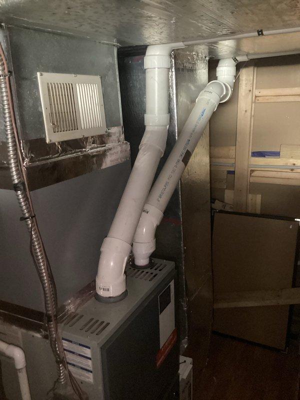 Completed comprehensive assessment of existing residential forced-air heating system for equipment replacement. Documented current furnace installation including all associated components: PVC venting configuration, flexible ductwork connections, air filtration system, and supply/return air pathways. Evaluated mechanical room layout and clearances to determine optimal replacement specifications. Photographed existing unit positioning, venting arrangements running through utility space, and all connection points to existing duct system. Provided detailed estimate for complete furnace replacement including removal of current equipment, installation of new high-efficiency heating unit with proper venting, and integration with existing ductwork infrastructure.