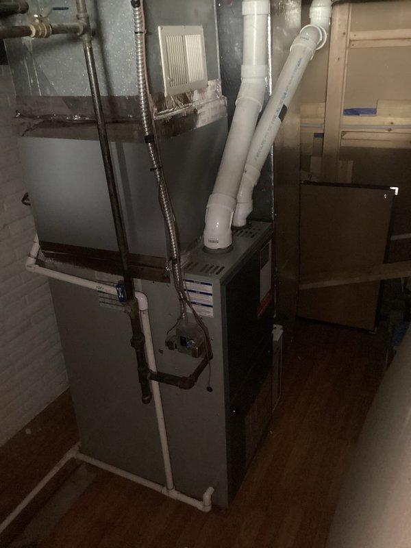 Completed comprehensive assessment of existing residential forced-air heating system for equipment replacement. Documented current furnace installation including all associated components: PVC venting configuration, flexible ductwork connections, air filtration system, and supply/return air pathways. Evaluated mechanical room layout and clearances to determine optimal replacement specifications. Photographed existing unit positioning, venting arrangements running through utility space, and all connection points to existing duct system. Provided detailed estimate for complete furnace replacement including removal of current equipment, installation of new high-efficiency heating unit with proper venting, and integration with existing ductwork infrastructure.