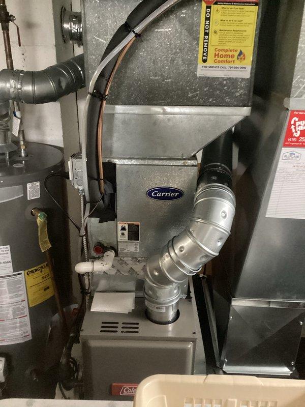 Conducted comprehensive assessment of existing residential HVAC system for complete air conditioning replacement. Evaluated current Carrier furnace installation, associated ductwork configuration, and overall system infrastructure in basement utility area. Documented existing equipment conditions including metallic ductwork routing, refrigerant line placement, and furnace unit specifications. Photographed current system layout showing rigid and flexible duct connections, copper tubing runs, and integration with existing water heater placement. Provided detailed replacement estimate for new air conditioning equipment compatible with current furnace and ductwork configuration.
