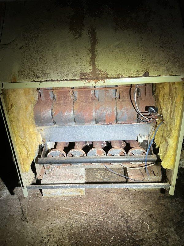Completed comprehensive tune-up on 10-year-old boiler system including inspection of burner assembly, heat exchanger, and combustion chamber. Noted significant age-related wear with heavy soot accumulation on upper chamber walls, surface corrosion on ductwork, and compressed insulation, but all components remain operational. Verified proper burner operation, checked electrical connections, and confirmed system functionality per manufacturer specifications.