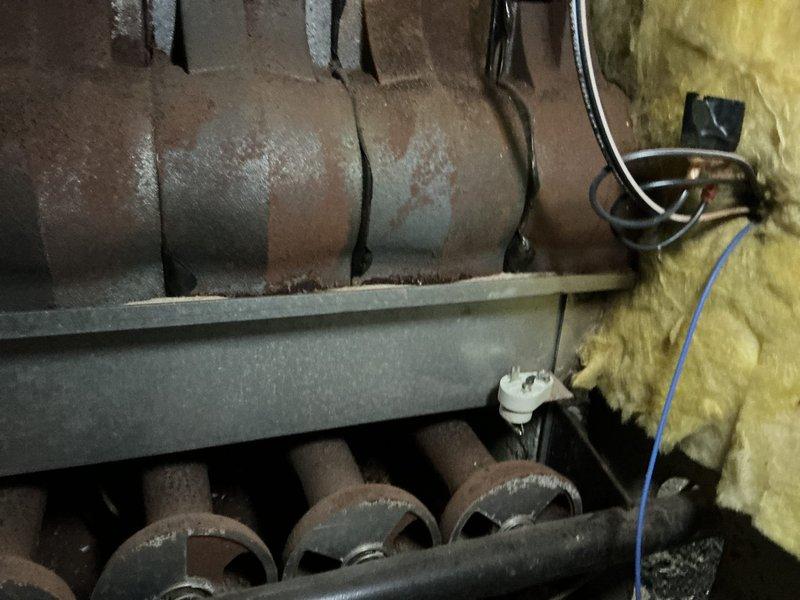 Completed comprehensive tune-up on 10-year-old boiler system including inspection of burner assembly, heat exchanger, and combustion chamber. Noted significant age-related wear with heavy soot accumulation on upper chamber walls, surface corrosion on ductwork, and compressed insulation, but all components remain operational. Verified proper burner operation, checked electrical connections, and confirmed system functionality per manufacturer specifications.