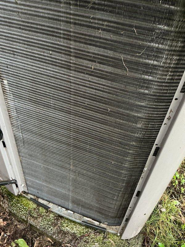 Responded to service call for 12-year-old air conditioning system not cooling properly. Upon inspection, found heavily soiled condenser coil with significant dirt and debris accumulation restricting airflow, along with damaged fins throughout the heat exchanger. Cleaned condenser coil, straightened bent fins, and verified proper system operation with unit cycling correctly and producing cold air.