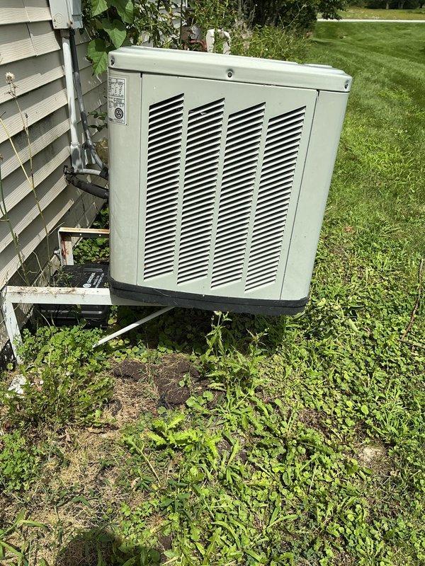 Responded to no cooling complaint on 10+ year old gas-powered HVAC system with outdoor condenser unit. Performed diagnostic inspection of exterior condenser unit positioned on metal stand against house exterior, verified unit accessibility and documented equipment condition with photos showing functional metal casing, intact louver panels, and proper electrical disconnect installation. System evaluated for age-related performance issues typical of equipment exceeding decade of service life.