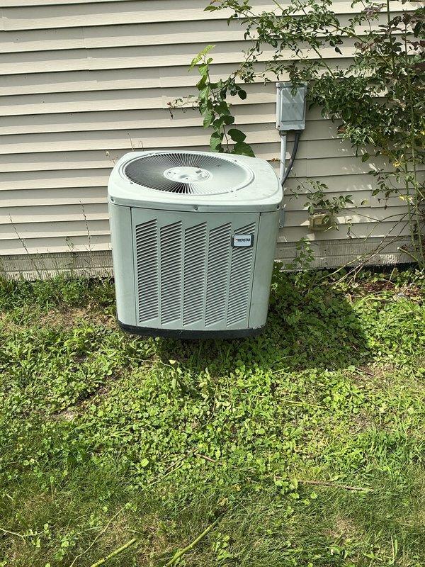 Responded to no cooling complaint on 10+ year old gas-powered HVAC system with outdoor condenser unit. Performed diagnostic inspection of exterior condenser unit positioned on metal stand against house exterior, verified unit accessibility and documented equipment condition with photos showing functional metal casing, intact louver panels, and proper electrical disconnect installation. System evaluated for age-related performance issues typical of equipment exceeding decade of service life.