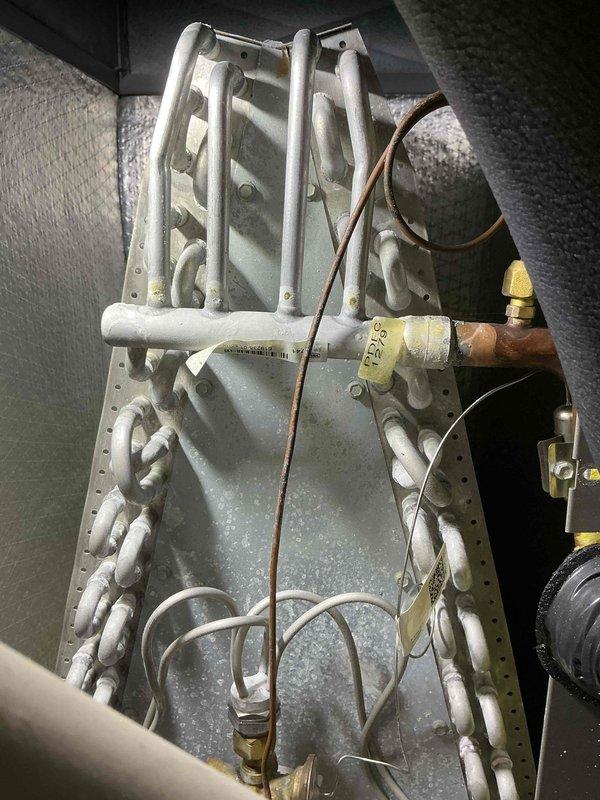 Completed scheduled biennial cooling maintenance visit on HVAC system. Performed comprehensive inspection of evaporator coil assembly, including A-frame coil configuration, refrigerant lines, and brass valve connections. Documented condition of serpentine tubing, copper piping, and control wiring. Verified proper installation of evaporator coil within air handler cabinet and checked for adequate airflow clearance. System operating within normal parameters upon completion of maintenance service.