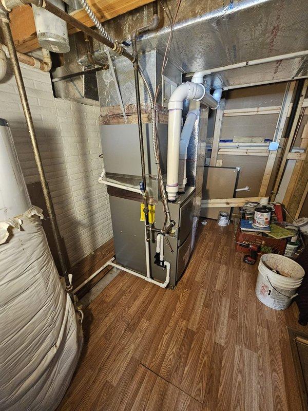 Completed installation of upflow 90% efficiency two-stage furnace rated at 110,000 BTU with dimensions 21" x 28" x 40" in basement utility area. Installed evaporator coil measuring 21" x 21" x 18" with required spacer for proper fitment, ensuring level placement and secure mounting to structural elements. Ran approximately 50 feet of 3-inch PVC venting system, properly pitched and terminated per manufacturer specifications and local code requirements. Installed new programmable thermostat and verified proper communication with two-stage heating operation. Completed all electrical connections, tested system operation through full heating cycles, and confirmed proper airflow through ductwork connections.
