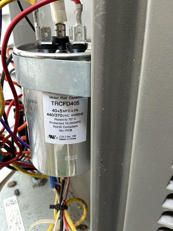 Performed routine maintenance on a 4-year-old air conditioning system. Inspected dual-run capacitor (40+5 MFD, 440/370VAC) and verified proper electrical connections and terminal integrity. Cleaned outdoor condenser unit, checked coil fins for proper spacing and airflow, and cleared debris from equipment pad.