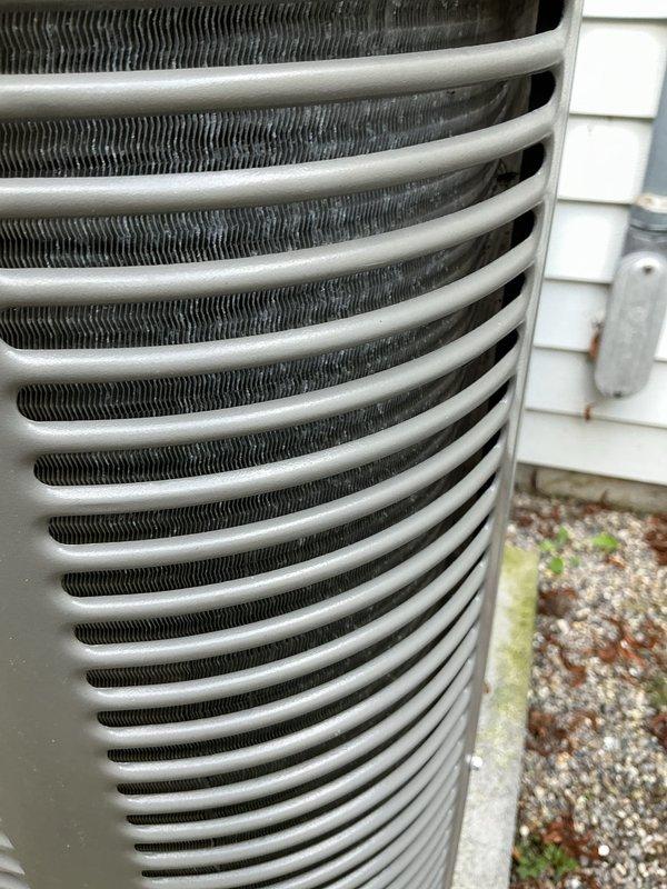 Performed routine maintenance on a 4-year-old air conditioning system. Inspected dual-run capacitor (40+5 MFD, 440/370VAC) and verified proper electrical connections and terminal integrity. Cleaned outdoor condenser unit, checked coil fins for proper spacing and airflow, and cleared debris from equipment pad.