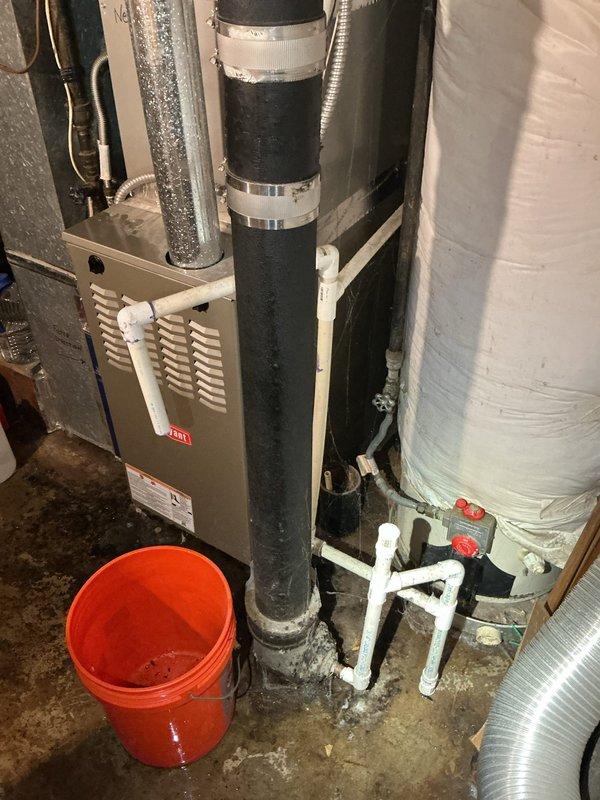 # HVAC Tune-Up Completed

Performed routine maintenance tune-up on a 6-year-old air conditioning system. Upon arrival, discovered active water intrusion and flooding in the mechanical room affecting the utility area where the AC equipment, furnace, and water heater are located. Standing water was present on both concrete and tile flooring surfaces throughout the space. Completed standard AC tune-up procedures including system inspection and performance verification. Documented the flooding condition with photos for customer records, noting the water accumulation near HVAC equipment, plumbing components, and drainage systems. Orange bucket was observed collecting water near vertical piping. The flooding issue requires immediate attention from a plumber to identify and repair the source of water intrusion to prevent potential damage to mechanical equipment.