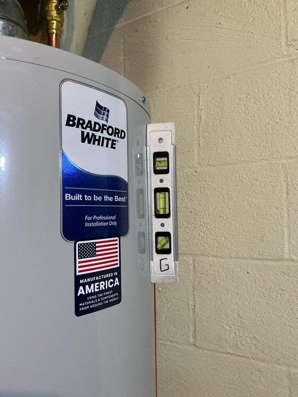 Replaced existing 40-gallon residential water heater with new Bradford White unit in basement utility room. Removed old water heater and installed new tank, connecting copper supply and discharge lines to existing plumbing infrastructure. Verified proper level installation and ensured all connections were secure. Unit installed adjacent to existing HVAC system with appropriate clearances maintained for safety and code compliance.