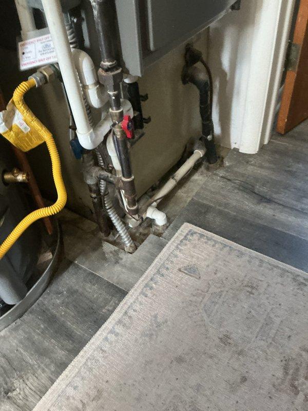 Completed comprehensive HVAC system tune-up including full system inspection and filter evaluation. Inspected water heater utility connections, gas line installation, and associated plumbing components to ensure proper clearances and safe operation of mechanical systems. Verified air filter condition in return air housing, confirmed proper installation and adequate airflow through pleated media filtration system.