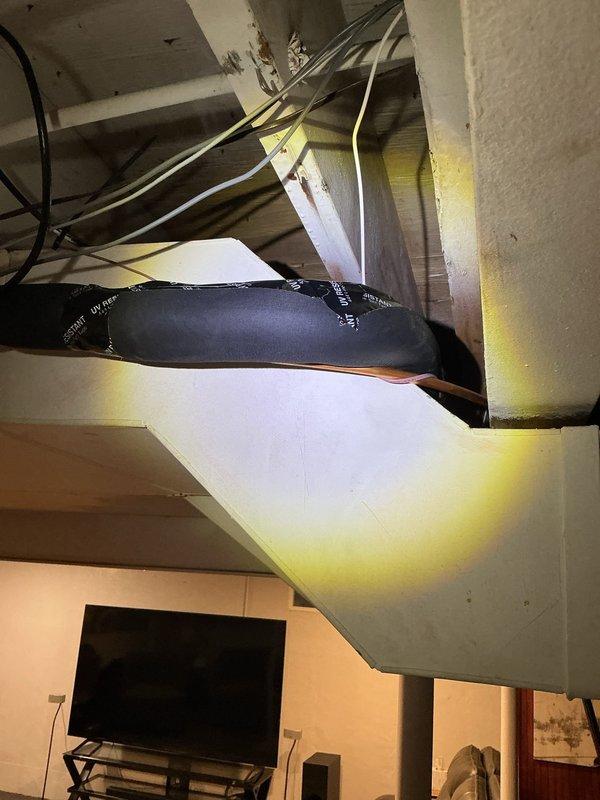 Responded to inspection correction for missing line set insulation in basement area. Located approximately 18 inches of exposed refrigerant line above ductwork that was lacking proper insultube coverage, resulting in condensation dripping onto ductwork and floor below. Installed appropriate insulation on exposed copper line set section to prevent further moisture accumulation and documented completed repair with photos for reinspection verification.
