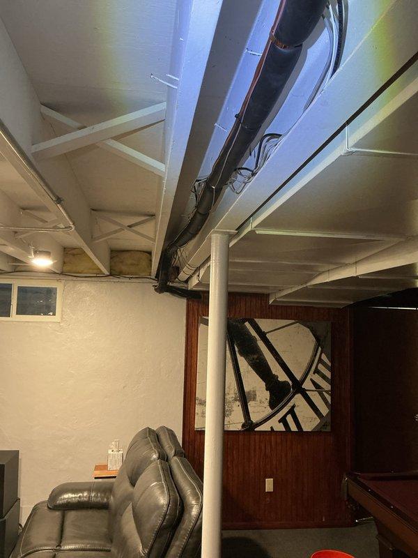 Responded to inspection correction for missing line set insulation in basement area. Located approximately 18 inches of exposed refrigerant line above ductwork that was lacking proper insultube coverage, resulting in condensation dripping onto ductwork and floor below. Installed appropriate insulation on exposed copper line set section to prevent further moisture accumulation and documented completed repair with photos for reinspection verification.