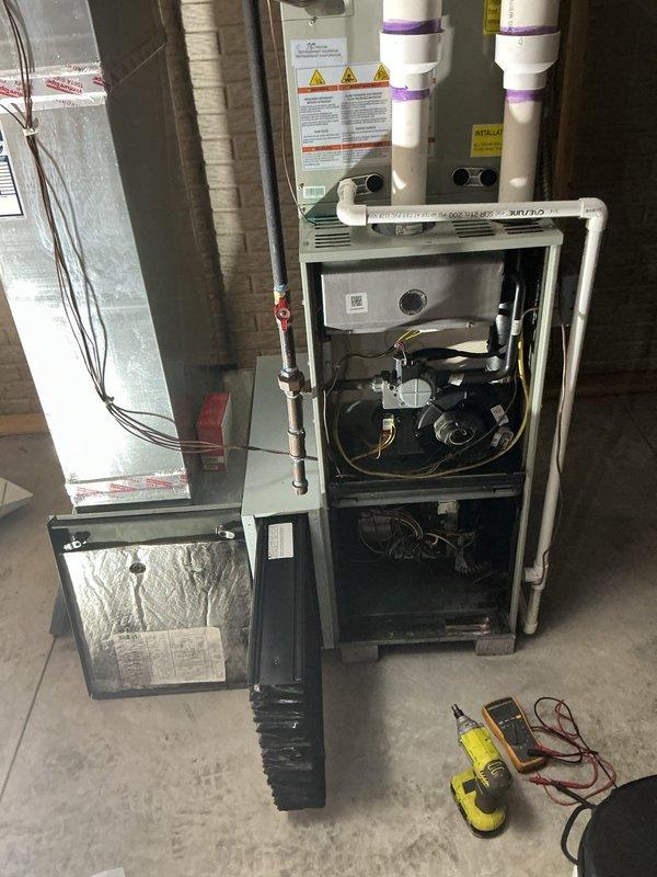 Responded to service call for furnace assessment following basement fire incident. Performed comprehensive visual inspection of furnace cabinet, internal components, electrical control board, wiring harnesses, and blower assembly. Utilized multimeter to test electrical circuits and verify system integrity. Removed access panels to examine interior compartment for fire damage, heat exposure, soot contamination, and compromised components. Inspected control board for signs of thermal damage, melted connections, or electrical shorting. Evaluated blower motor, wiring bundles, copper refrigerant lines, and condensate drain system for structural damage. Documented equipment condition with photographs showing internal components, electrical connections, and overall unit status to provide customer with detailed assessment for repair versus replacement decision.