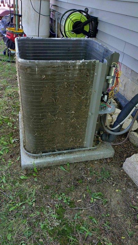 Completed comprehensive tune-up service on a 2-year-old residential air conditioning system. Upon arrival, found exterior condenser unit heavily soiled with accumulated dirt, debris, and organic matter significantly restricting airflow through coil fins. Performed thorough coil cleaning to restore proper heat transfer efficiency and system performance, ensuring optimal operation for the cooling season.