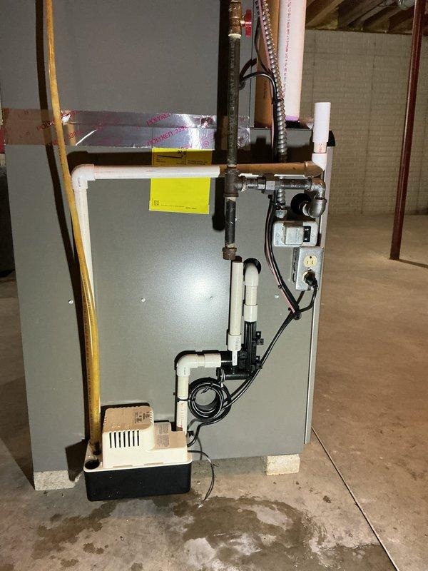 Responded to service call for water puddle near recently installed HVAC system. Performed thorough inspection of furnace and air conditioning unit to identify source of water accumulation. Examined condensate drain system, drain pan, and all PVC drainage connections for proper installation and functionality. Verified condensate pump operation and checked for any blockages in drain lines. Inspected unit for refrigerant leaks and confirmed all connections were secure. System found to be operating within normal parameters with no mechanical deficiencies identified.
