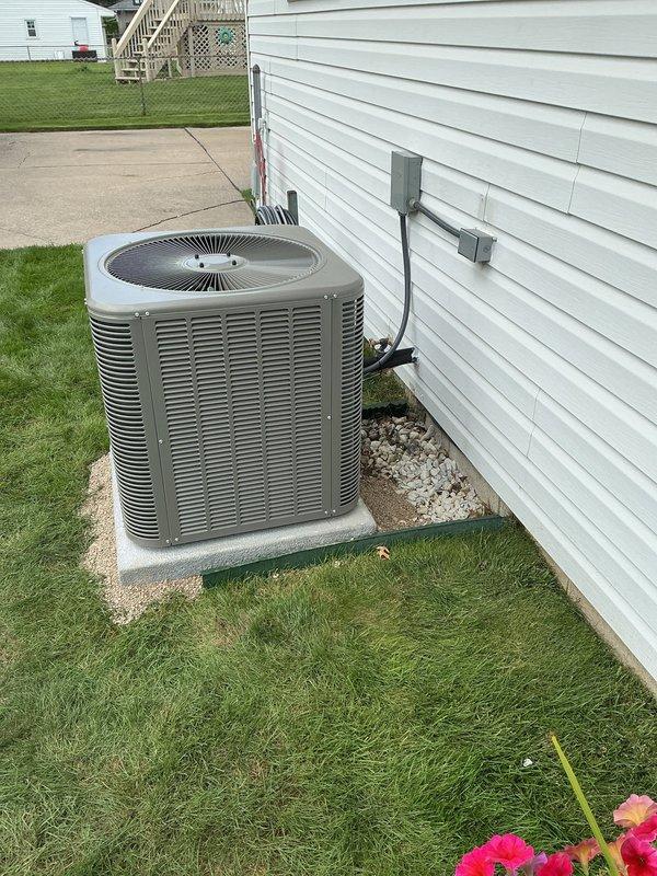 Completed full HVAC system replacement including outdoor condensing unit and indoor furnace. Installed new air conditioning unit with 14.3 SEER2 rating, 28,600 BTU cooling capacity, operating on R454B refrigerant with 208V single-phase power. Unit positioned on new concrete ground pad with proper leveling and gravel base. Ran 30-foot refrigerant lineset with 3/8" liquid line and 3/4" suction line connections. Installed matching evaporator coil in upflow orientation with 16"x15.25" return and supply plenum dimensions. Replaced existing Rheem furnace, maintaining 46" height clearance and 73" measurement from cement to bottom of supply trunk. Upgraded exhaust venting system to B-Vent specifications for proper combustion air discharge. Fabricated custom sheet metal transition collar to adapt B-width furnace connection to existing C-width plenum, ensuring proper airflow distribution. Installed 30-amp disconnect switch and electrical whip with appropriate wire insulation for safe power deliv