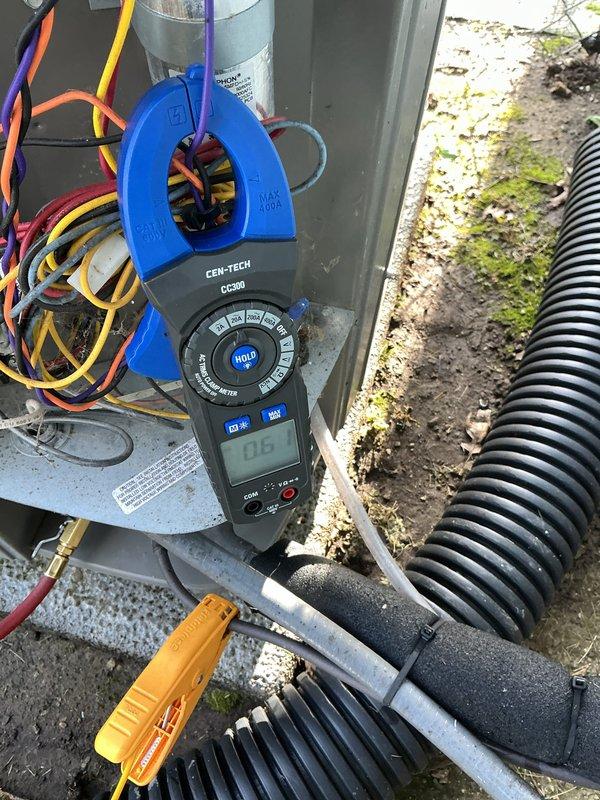 Completed routine AC tune-up on 6-year-old outdoor condensing unit. Performed electrical diagnostics using clamp meter to verify proper amperage draw and system operation. Inspected condenser coil which showed moderate accumulation of dirt, dust, and debris between fins; noted discoloration and particulate buildup requiring cleaning to maintain optimal heat transfer efficiency and system performance.