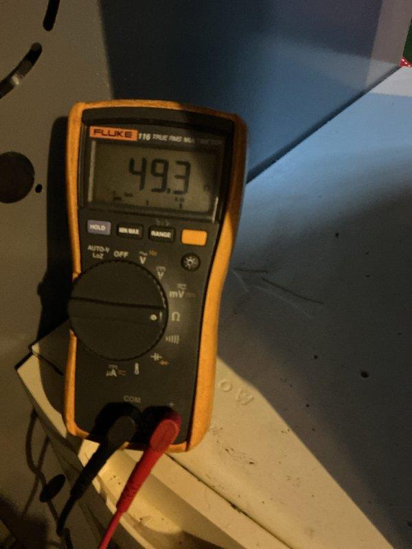 Completed heating system tune-up and safety inspection. Performed electrical diagnostics using multimeter, recording voltage reading of 493V at the equipment. Inspected heating unit located in storage area, verified proper operation of all components, and confirmed system is functioning within normal parameters for the heating season.