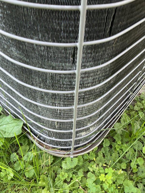 Completed scheduled cooling maintenance on 23-year-old air conditioning and furnace system. Performed comprehensive inspection of outdoor condenser unit, including examination of heat exchanger coils, protective grille, and overall unit condition. Coils showed normal age-related weathering with some mineral deposits and debris accumulation between fins. Verified proper placement and clearance around unit. System operational upon completion of maintenance procedures.