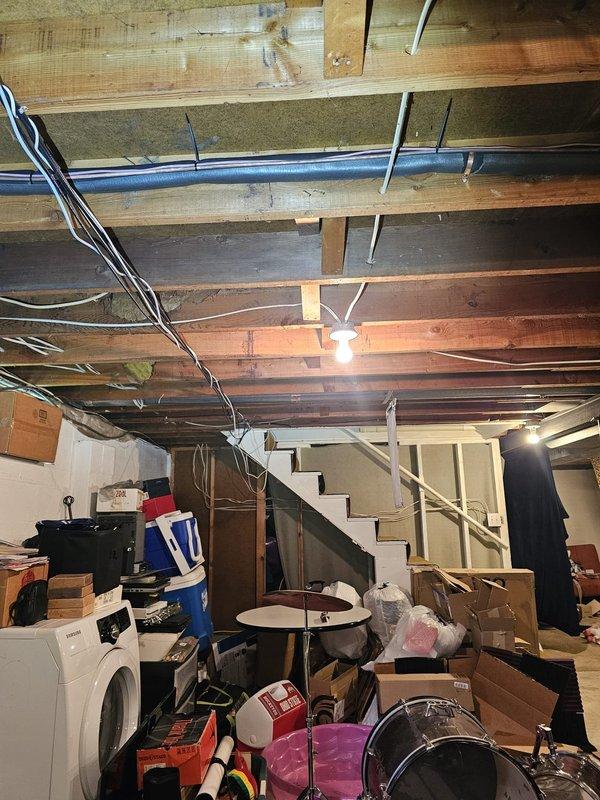 Responded to callback for line set insulation repair in basement area above ductwork. Located exposed refrigerant line set running horizontally along ceiling joists where insulation had become damaged or displaced. Removed deteriorated insulation sections and installed new foam insulation over copper refrigerant lines to prevent condensation and maintain system efficiency. Secured insulation properly with appropriate fasteners and verified complete coverage of line set from air handler connection point through basement ceiling area. Documented completed repairs with photos showing proper insulation installation and routing alongside existing ductwork and mechanical systems.