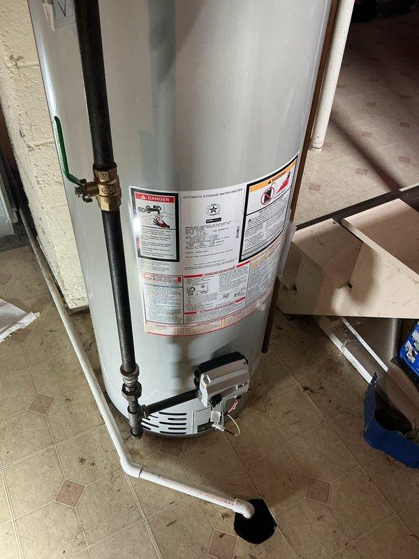 Replaced existing water heater with a new Bradford White 40-gallon atmospheric vent natural gas unit in the utility room. Installed unit includes Defender Safety System with Advanced ScreenLok Technology flame arrestor, Vitraglas tank lining with Microban antimicrobial protection, Bradford White ICON System intelligent gas control, and Hydrojet Total Performance System for sediment reduction. Connected copper supply lines with brass fittings to top-mounted inlet and outlet ports. Installed draft hood vent connector for proper atmospheric venting to building exterior. Positioned unit on white plastic overflow pan on existing tile floor. Verified all gas connections, tested for leaks, and confirmed proper venting operation. Unit operational and ready for service.