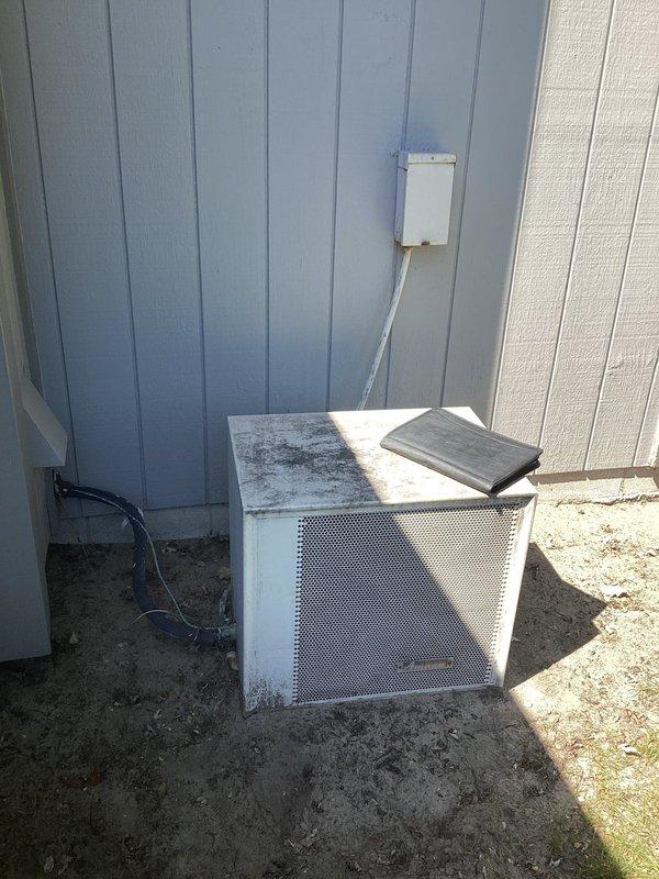 Conducted comprehensive assessment of existing HVAC system for complete furnace and air conditioning replacement. Evaluated outdoor condensing unit showing signs of weathering and age, with displaced top panel and visible deterioration on exterior surfaces. Unit currently positioned on ground level against building exterior with electrical conduit connection to wall-mounted junction box. Assessed indoor equipment configuration including furnace with accessible internal components, air handler, and associated ductwork and PVC venting systems. Documented current system layout, electrical connections, refrigerant line routing, and condensate drainage infrastructure. Provided detailed replacement estimate covering removal of existing equipment and installation of new high-efficiency furnace and air conditioning system sized appropriately for the residence.