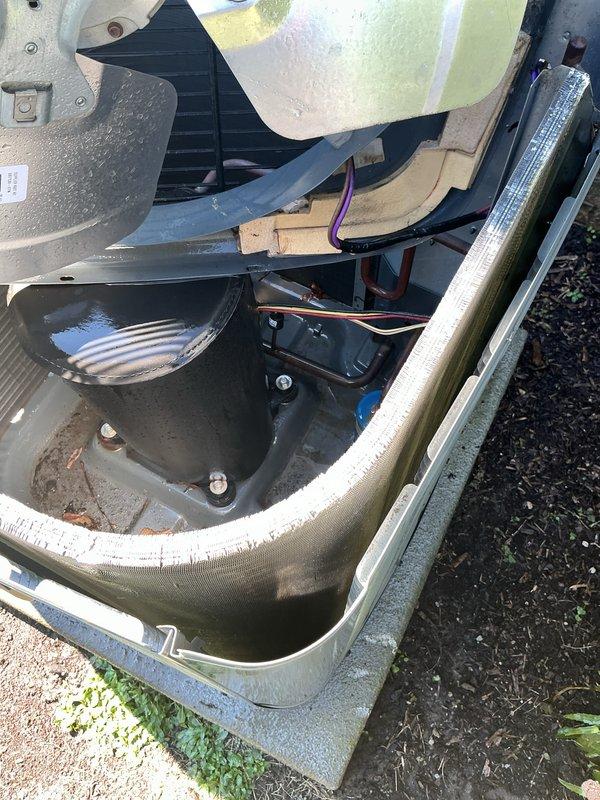 Completed comprehensive AC tune-up on outdoor condensing unit, including inspection of compressor, electrical connections, and base compartment. Verified proper operation of all components, checked refrigerant levels, cleaned debris from base pan, and confirmed electrical disconnect box functionality. Unit tested and operating within normal parameters.
