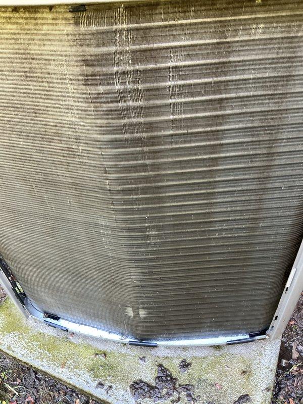 Completed preventative maintenance service on a 4-year-old electric cooling system under the MVP Cool maintenance program. Inspected outdoor condenser unit, which showed normal weathering and environmental debris accumulation on exterior surfaces and concrete pad. Verified air filter condition, confirming clean pleated filter with no dirt buildup or damage, indicating proper recent maintenance or replacement.