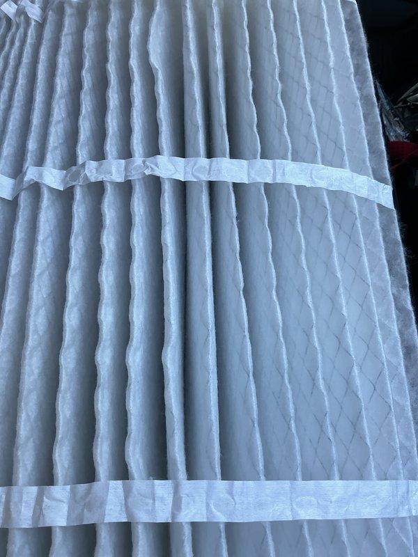 Completed preventative maintenance service on a 4-year-old electric cooling system under the MVP Cool maintenance program. Inspected outdoor condenser unit, which showed normal weathering and environmental debris accumulation on exterior surfaces and concrete pad. Verified air filter condition, confirming clean pleated filter with no dirt buildup or damage, indicating proper recent maintenance or replacement.