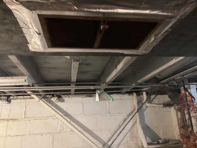 Conducted on-site evaluation for furnace replacement at residential property. Assessed existing Amana furnace installation in basement utility area, documenting current system configuration including PVC venting, copper refrigerant lines with insulation, and electrical connections. Inspected ceiling infrastructure and ductwork access points to determine compatibility requirements for new equipment installation. Photographed existing setup and provided comprehensive replacement estimate to homeowner.