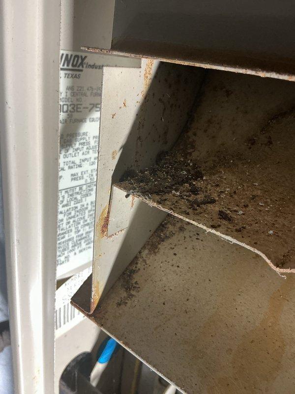 Responded to service call for 30+ year old air conditioning system experiencing intermittent operation requiring multiple power cycles before starting. Performed diagnostic inspection of HVAC system including furnace with electronic air cleaner and humidifier unit installed in 2013. Documented equipment condition with photos showing significant rust staining and deterioration on interior cabinet surfaces, indicating moisture exposure and age-related wear. Quoted maintenance service to address operational issues with cooling system and non-functioning humidifier component.