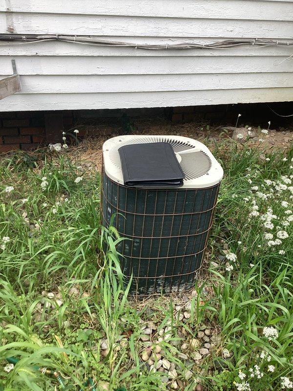 Provided comprehensive estimate for complete HVAC system replacement including both air conditioning condenser unit and furnace. The existing outdoor AC unit shows significant age and lack of maintenance with overgrown vegetation surrounding the equipment, indicating need for replacement. Blower motor was replaced as an interim repair, with cost to be credited toward new system installation if customer proceeds with full replacement.