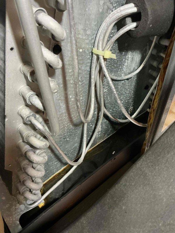Completed comprehensive tune-up service on 25-year-old air conditioning system. Performed detailed inspection of evaporator coil assembly, refrigerant lines, and electrical connections; documented existing component condition showing age-appropriate wear on copper tubing and heat exchanger surfaces. All accessible components checked and system operational upon completion.