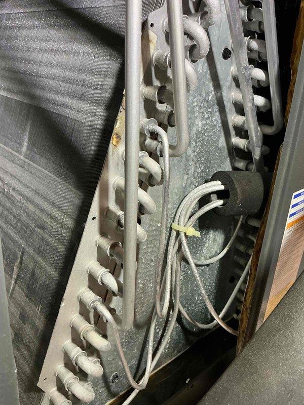 Completed comprehensive tune-up service on 25-year-old air conditioning system. Performed detailed inspection of evaporator coil assembly, refrigerant lines, and electrical connections; documented existing component condition showing age-appropriate wear on copper tubing and heat exchanger surfaces. All accessible components checked and system operational upon completion.