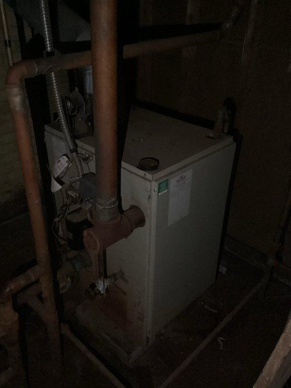 Conducted comprehensive assessment of existing steam boiler system in basement mechanical room for replacement estimate. Evaluated current boiler unit mounted on metal stand with multiple copper piping connections, flexible metal conduit, and associated ductwork infrastructure throughout the space. Documented equipment condition, existing piping configuration, and spatial constraints to determine appropriate replacement specifications and installation requirements.