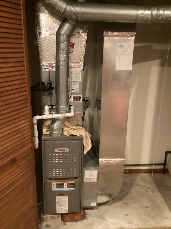Conducted comprehensive assessment of existing residential HVAC system for air conditioning replacement estimate. Evaluated current Lennox furnace installation in basement utility area, including ductwork configuration, condensate drainage system, and overall equipment accessibility. Documented outdoor condenser unit positioned against exterior brick wall, noting unit age, condition, and electrical service connections. Assessed existing infrastructure including gas meter proximity, electrical junction box placement, and drainage considerations. Photographed indoor and outdoor components to provide detailed documentation for replacement equipment specifications and installation planning.