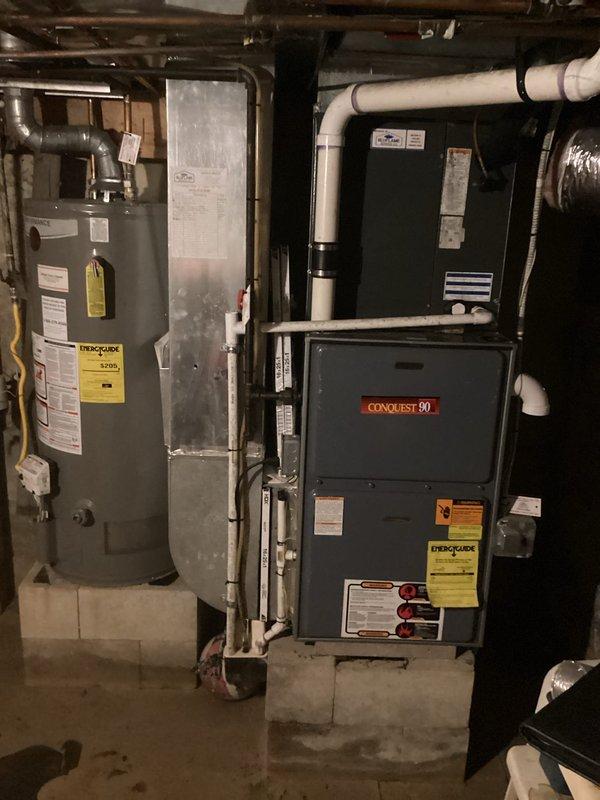 Completed estimate for full HVAC system replacement at vacant residential property. Assessed existing Conquest 90 furnace and air conditioning system in basement utility room, documented equipment specifications and current installation configuration including ductwork connections, and provided replacement recommendations for both heating and cooling units.