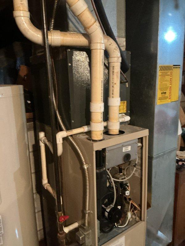 Responded to service call for furnace experiencing moisture issues during operation. Upon inspection, found condensate drainage system requiring attention with PVC vent pipes showing signs of water infiltration. Verified proper operation of furnace components, checked condensate trap and drainage lines, and ensured all venting connections were secure to prevent future moisture problems.