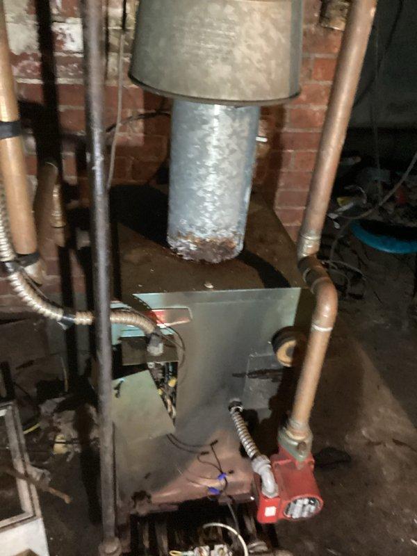 Conducted comprehensive on-site assessment of existing boiler system and associated mechanical infrastructure in basement utility area. Documented current conditions of HVAC ductwork, copper piping network, insulated supply lines, and mechanical equipment including circulator pump assembly. Evaluated metal ductwork system with insulated cylindrical sections, rectangular plenum connections, and support framework. Inspected copper pipe routing, flexible conduit installations, and protective coverings on insulated piping. Photographed all relevant components to support estimate preparation for boiler replacement or upgrade project.